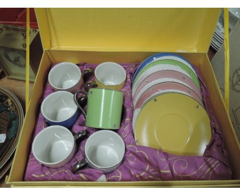 A boxed set of harlequin coffee cups and saucers by Carolyn Quartermaine
