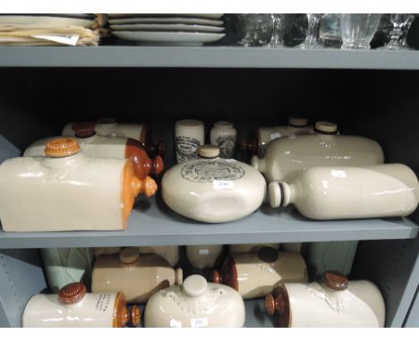 A selection of vintage stone ware warmers and advertising jars 