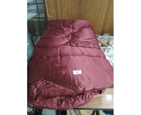 A vintage quilted maroon eiderdown by Pelaw