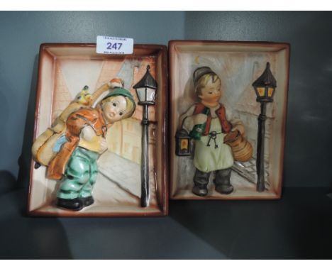 A pair of vintage ceramic figural wall plaques in a Goebels style