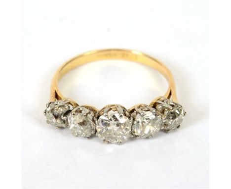 A FIVE STONE DIAMOND RING  stamped '18ct' and 'Plat', the graduated old cuts totalling approximately 1.9 carats, finger size 