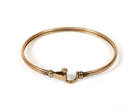 A BANGLE  set with an old cut brilliant diamond of approximately 0.05 carats, unmarked, internal diameter 6.4cm, 9g gross.