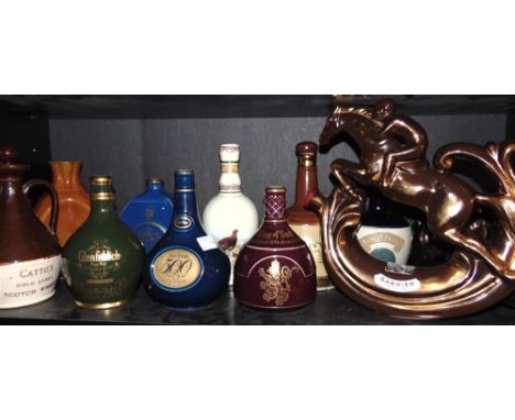 BREWERIANA - ELEVEN ASSORTED DECANTERS  comprising a Garnier 'abricotine' lustreware decanter, in the form of a leaping raceh