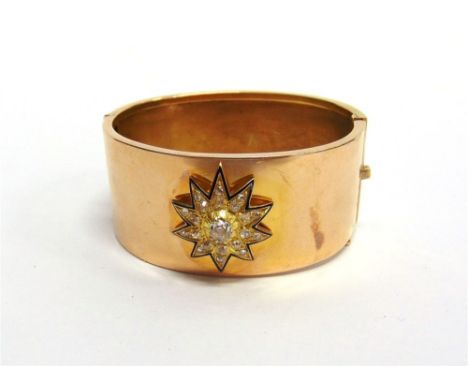 A VICTORIAN DIAMOND CLUSTER SET HINGED BANGLE the detachable starburst cluster with dark blue enamel trim with a central silv