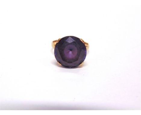 A SINGLE STONE DRESS RING stamped '14', set with a synthetic colour change corundum, finger size N, 5g gross, cased 