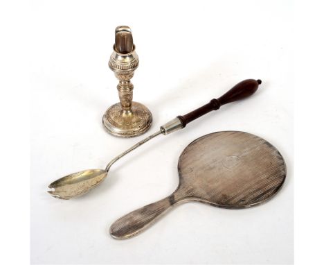 A LOADED SILVER DESK CANDLESTICK a silver hand mirror; a silver salad serving fork; with wooden handle; and a silver bottle p