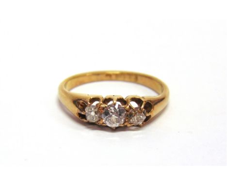 A LATE VICTORIAN THREE STONE DIAMOND 18 CARAT GOLD RING date letter erased, the graduated old brilliant cuts totalling approx