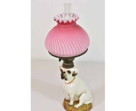 A Staffordshire pottery Bull Terrier dog converted to oil lamp pink milk glass shade (restored), dog, with tiny chip to base,
