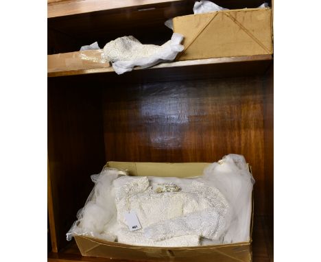 A collection of various vintage wedding dresses and veils including a high necked 1950's gold and cream dress, a daisy lace d