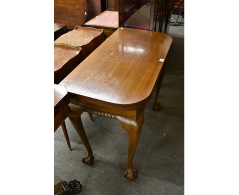 A 1920s mahogany card table in the George I style with gadroon carved front and cabriole legs with ball and claw feet. 