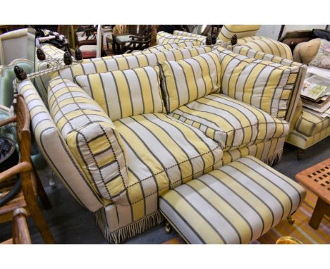 A Knowle style sofa with matching footstool in a striped pale yellow upholstery (option) 