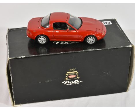 A Kyosho 1/18 scale diecast model of a Mazda Miata MX-5, red, with outer card box only