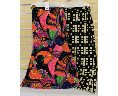 Two vintage Martinique, London maxi skirts,one with black ground, stylized floral stem design in bright pinks, greens, blues 