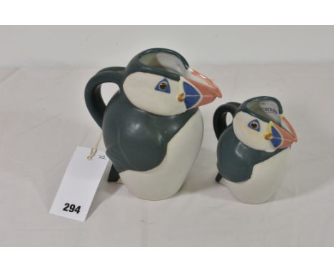 A graduated pair of ceramic puffin jugs. (2)