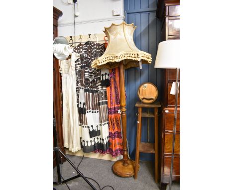 A turned and carved walnut standard lamp 1920s, with knopped and fluted column and period tasselled shade. 