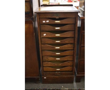 A Globe Wernicke filing cabinet with nine pull out trays and a pull up concertina front with brass handle. (48cm x 103cm) 