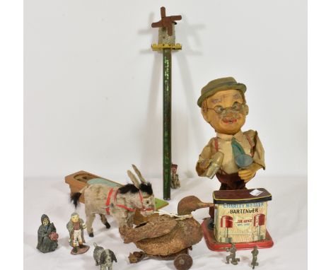 A collection of vintage/antique toys to include a Dickens lead figure, wind up donkey, Charley Weaver bartender etc