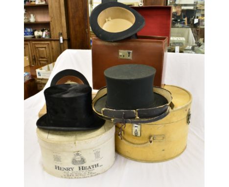 A collection of vintage/ antique hats comprising a boxed bowler hat by Hubert Johnson; a boxed silk top hat by Henry Heath Lt