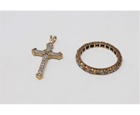 A 9ct gold synthetic spinel eternity ring and a 9ct gold crucifix pendant CONDITION REPORT: 2.7g gross. 