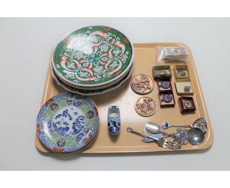 A tray of silver and other sports medals, plated caddy spoons and cutlery, cigarette cards, Delft shoe and pottery plates 