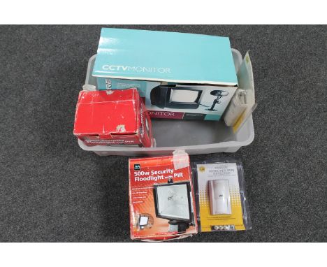 A plastic crate containing CCTV camera and monitors, two motion sensor floodlights, two Yale passive detectors 