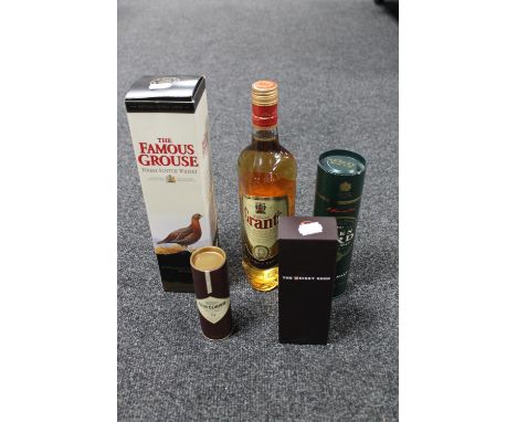 A basket of 70cl bottle of the Famous Grouse Scotch whisky in box, 70cl bottle of Grants finest Scotch whiskey, 20cl bottle o