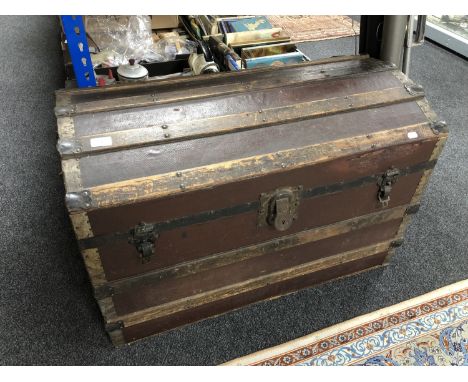 An early 20th century wooden bound travelling trunk 