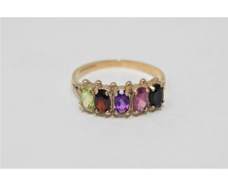 A 9ct gold multi stone ring set with sapphire, rhodalite, amethyst, garnet and peridot.