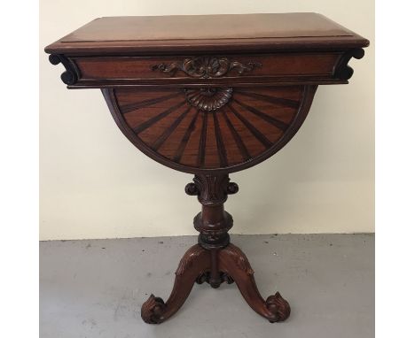 A mahogany Regency style Teapoy raised on decorative tripod feet.  Lift up lidded top above a semi circular shaped drawer.  A