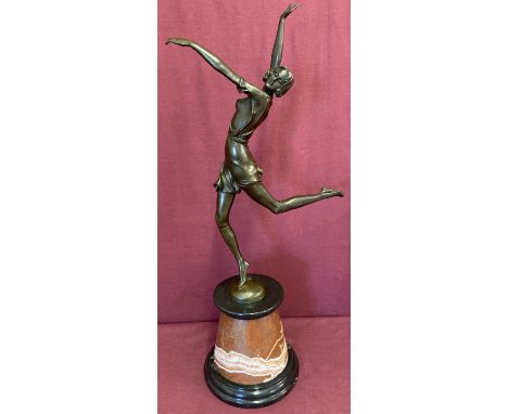 An Art Deco style bronze figure of a dancer, with signature and foundry mark to base.  Mounted on a black and red conical pli