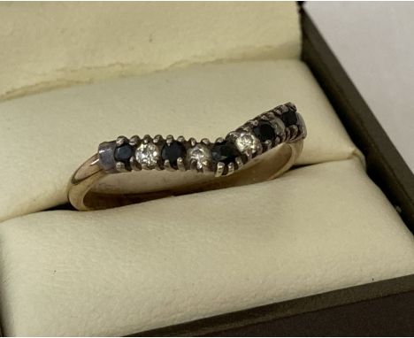 A vintage gold on silver sapphire and clear stone set wishbone dress ring.  Hallmarks to inside of band, also marked "Golsil"