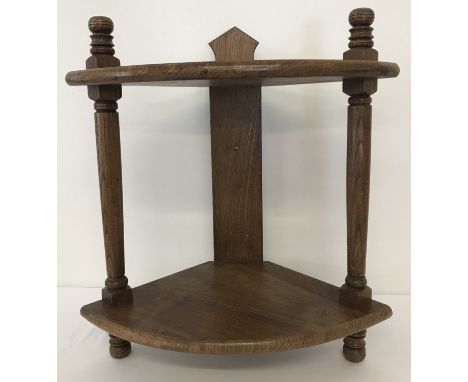 A vintage medium oak 2 tier corner shelf with turned detail to columns.   Approx. 50cm tall.