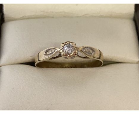 A 9ct gold diamond solitaire ring with detail to shoulders. Stone size approx. 0.07ct.  Ring size O.  Total weight approx. 1.