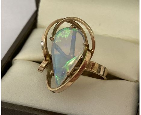 A 9ct gold bespoke contemporary design dress ring set with large teardrop shaped opal.  Inside of band marked 9ct and makers 