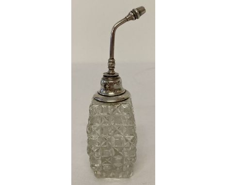A sterling silver topped, cut glass perfume atomiser, with cross cut panel detail to glass bottle.   Approx. 14.5cm tall.
