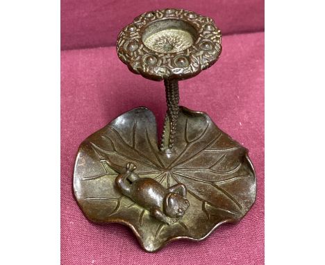 A small bronze candle holder in the form of a frog on a lily pad.   Approx. 5.5cm tall x 7.5cm diameter.