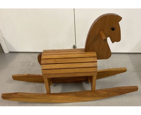 A children's modern design pine wooden rocking horse with slatted dome style body/seat.   Approx. 60 cm tall x 94 cm long (in