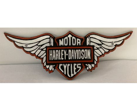 A modern cast iron Harley Davidson wall hanging plaque in the shape of wings.  Black, red and white colourway.  Approx. 39cm 