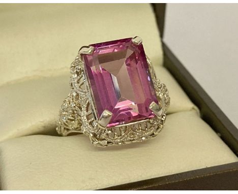 A 9ct gold Gems TV cocktail ring set with large square cut pink tourmaline.&nbsp;Decorative filigree style detail to ring mou