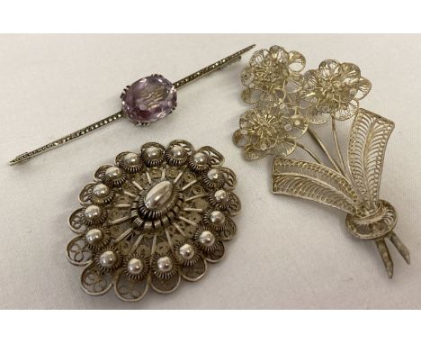 3 vintage white metal brooches. An Art Nouveau bar brooch set with amethyst and marcasite's.  Together with 2 filigree design