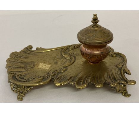 A vintage classical design copper and brass ink stand with ceramic liner to ink well.   Approx. 8.5cm tall x 18cm long.