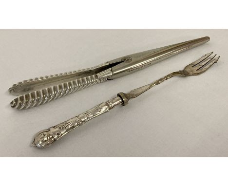 A pair of silver handled glove stretchers with German silver blades.  Together with a silver handled pickle fork. 