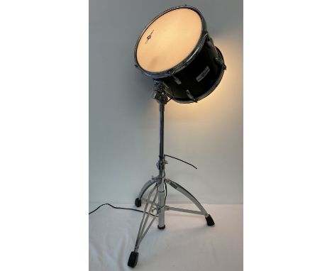 An unusual lamp made from a drum on an adjustable chrome tripod stand.  