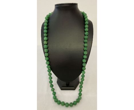 A 32" apple green jade beaded necklace, knotted between each bead.   Beads approx. 1.25cm diameter.