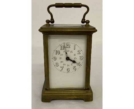 A vintage heavy brass carriage clock with enamel face. Glass panels to top, back and sides. Not working.  Approx. 11.5cm tall