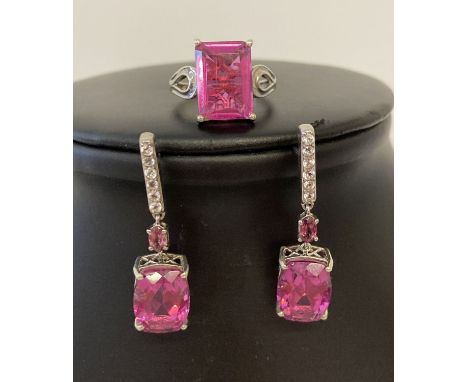 A matching silver dress ring and drop style earrings set with coated pink quartz and clear stones.  By STS Jewellery. Ring ma