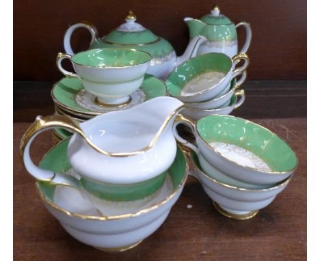 A Grosvenor China six setting tea service with water jug, some marked Copeland and some marked made for Maple & Co. Ltd.