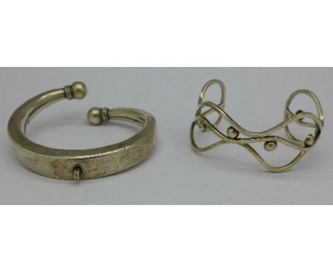A silver bangle and another bangle marked Mexico
