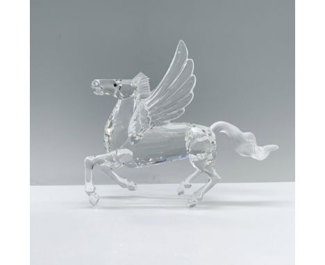 A clear crystal Pegasus designed to stand on hind legs and tail with wings spread wide featuring amber-colored eyes. Swarovsk
