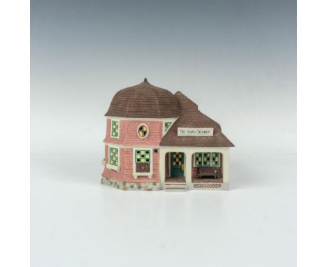 This hand-decorated item depicts the ice cream parlor of a turn-of-the-century resort town. Item #53305. Department 56 backst